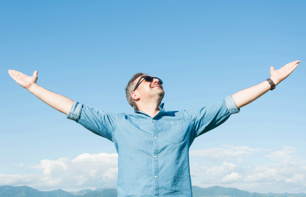 Business person with arms stretched out with confidence